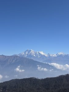 A panoramic view of majestic snow-capped mountains under a clear blue sky
