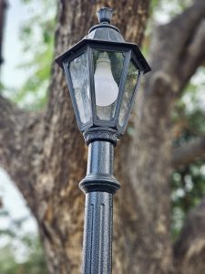 A classic black street lamp stands tall against a big tree in Kallampara, Feroke, Kozhikode. The soft daylight and blurred background give it a calm and simple look.
