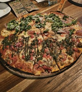 Homemade style pizza with vegetables and meat
