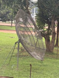 A ground satellite receiver placed in a position to receive waves of communication. 
