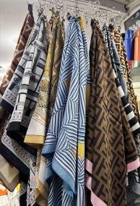A collection of vibrant scarves hanging on a display rack.
