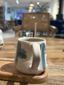 Ceramic mug on a wooden tray.