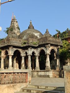 Detailed view of a traditional Indian temple with intricate stone carvings and heritage design in natural daylight.
