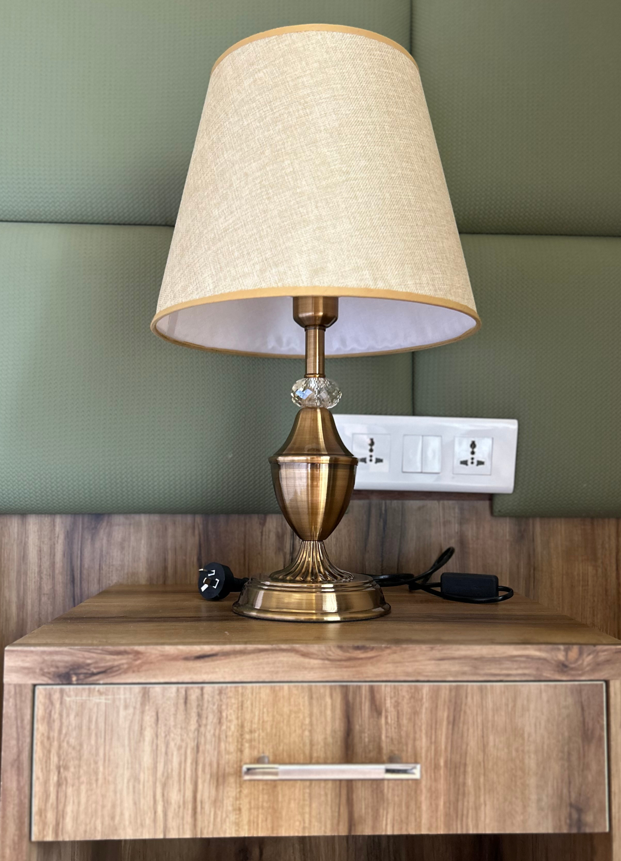A stylish bedside lamp rests on a wooden nightstand.