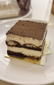 A decadent piece of chocolate cake displayed on a plate, showcasing its moist texture and creamy frosting.