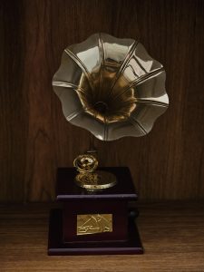 A classic vintage gramophone with a shiny brass horn placed on a wooden surface. The rich tones and clean composition give a timeless feel in Kozhikode, Kerala.