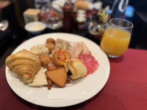 Indian style food on a plate with a glass of juice