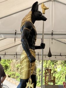 Statue of Anubis in black and gold colors.