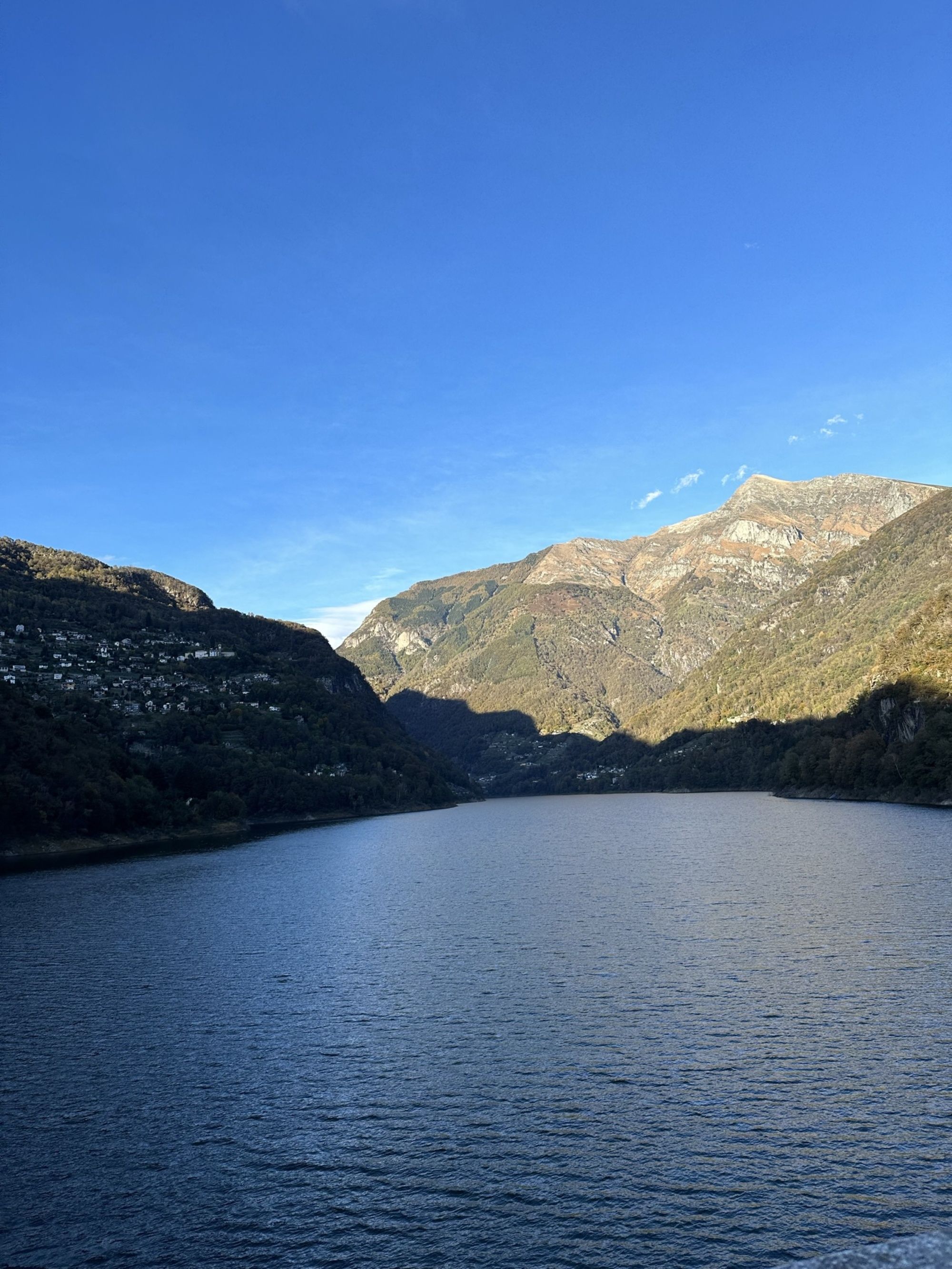 View of the Cannobio pier with mountains in the background in Italy.
