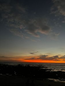 Sunset at Playa Avellanas, Costa Rica with sea and coral.
