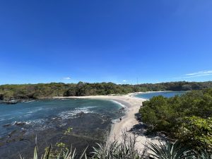 A view of Playa San Juanillo in Costa Rica, where a thin strip of sand separates two calm blue bays.