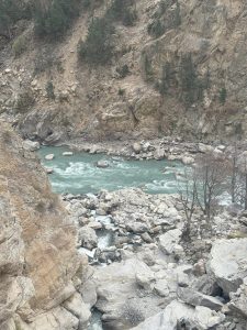 A gentle river flows below the hill station, winding through the landscape and enhancing the natural beauty.
