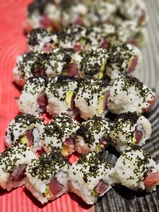 Fresh sushi rolls topped with black fish roe and filled with fish and avocado. A colorful and appetizing close-up food shot captured in Worli, Mumbai.