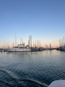 A boat sitting on water during sunset 