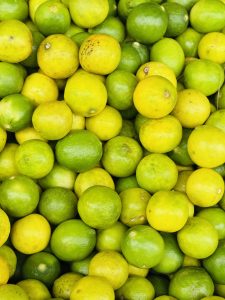 Close-up of many small limes in green and yellow shades.