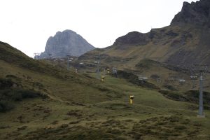 Cable car in the Swiss mountains, natural landscape, and surrounding mountains.