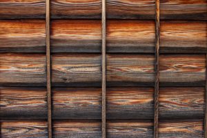 The wooden exterior walls of an old Japanese house. The wood grain and fittings are neatly arranged.
