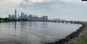 Manhattan Skyline from Libery Island, New Jersey featuring a mix of tall modern skyscrapers including a prominent tower, the One World Trade Center. 