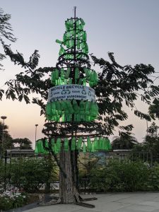 Tree made from recycled plastic bottles with eco message
