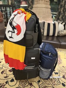 2 travel bags and a backpack with a Uganda flag covering from the side