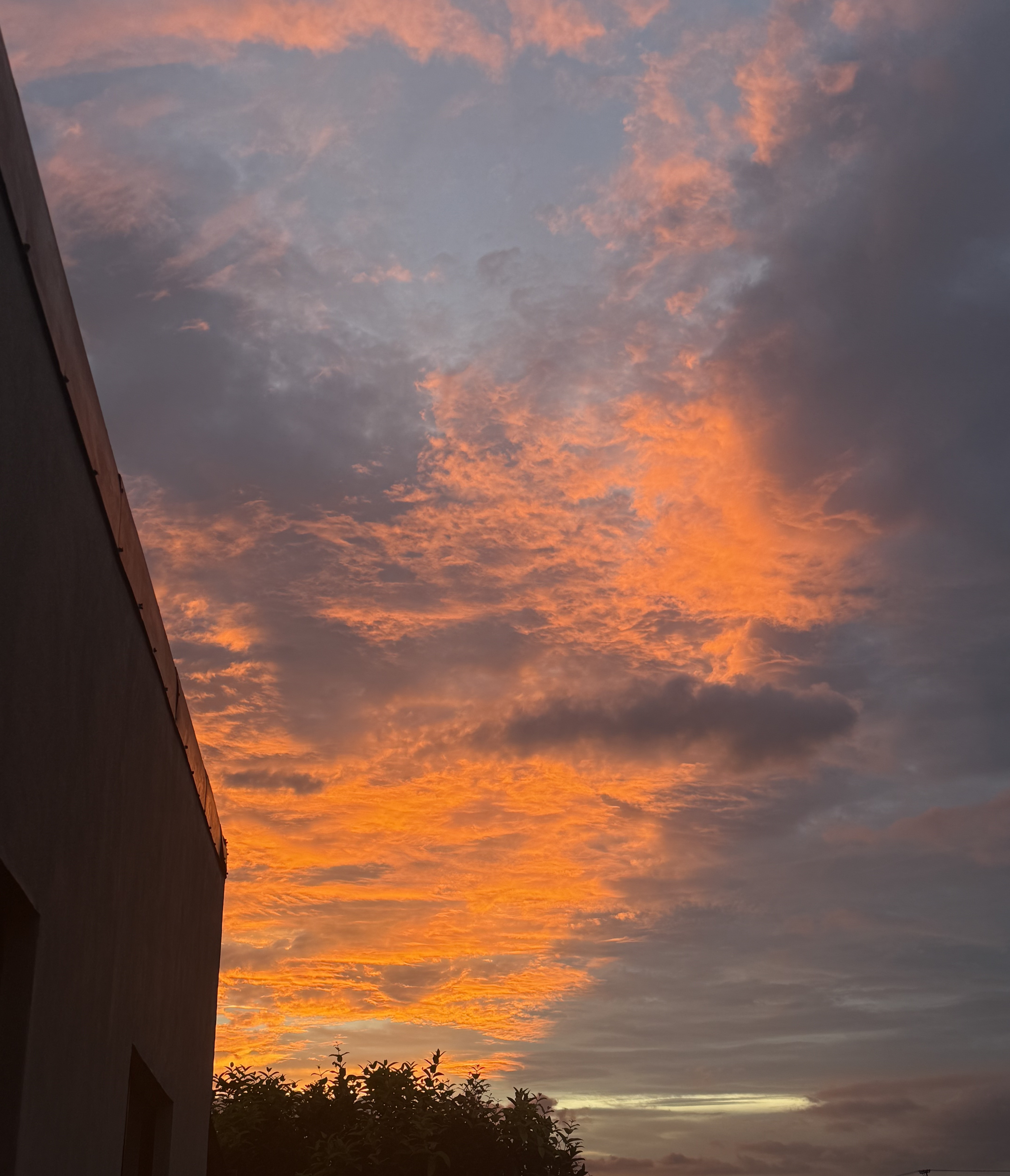 Orange sunset reflecting in the clouds over San José, Costa Rica.