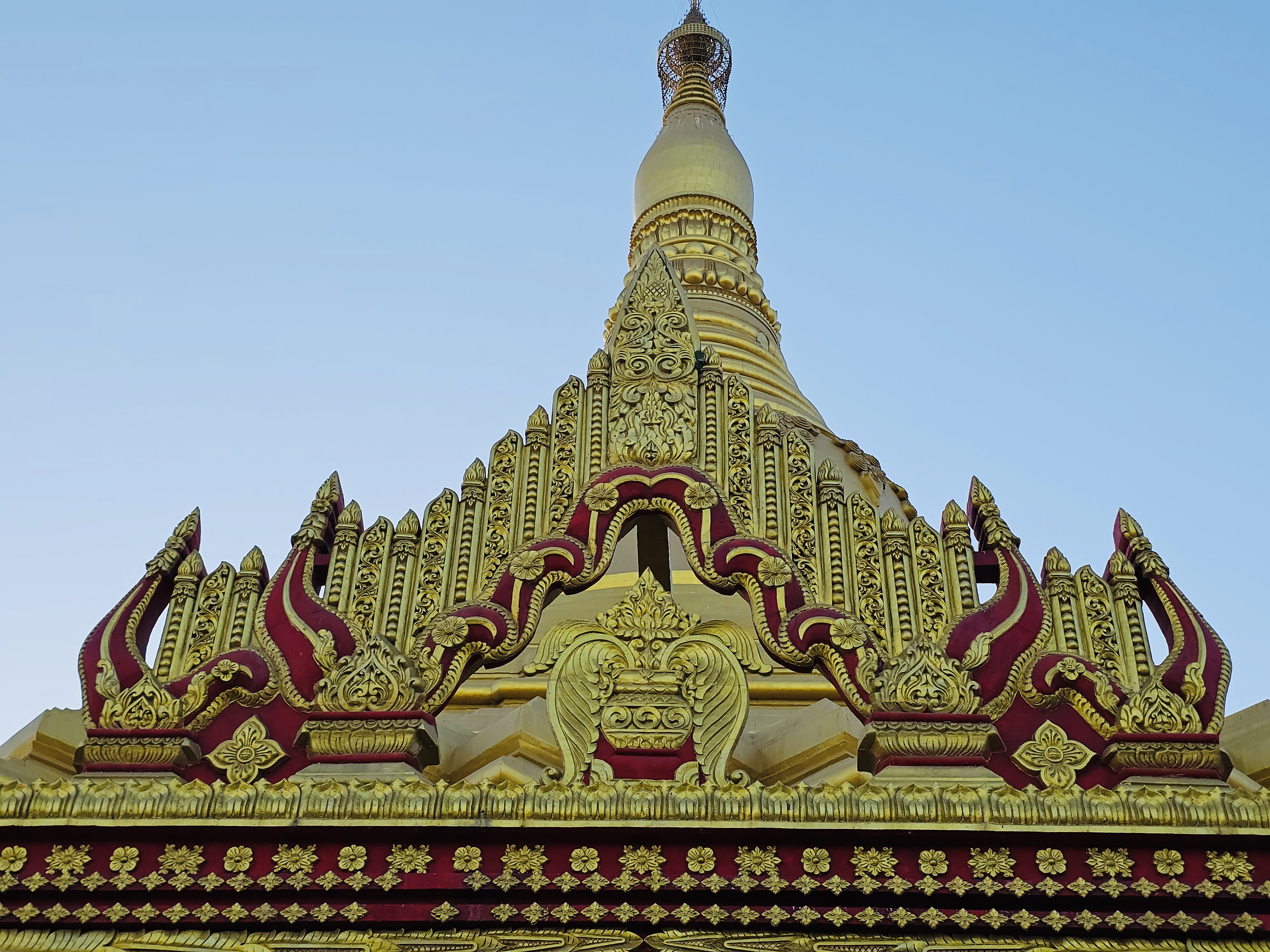 Detailed front view of the pagoda’s ornate design with red and gold patterns at Global Vipassana Pagoda, Gorai Village, Mumbai.