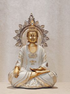 A calm Buddha statue in white and gold, placed indoors in the Global Vipassana Pagoda, Gorai Village, Mumbai. The peaceful expression and the soft background create a relaxing, spiritual mood.
