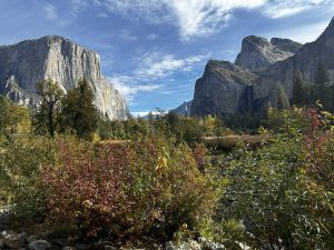 
A scenic view of a mountainous landscape featuring steep granite cliffs on either side.