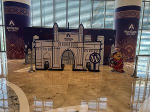 WordCamp Asia 2026 Mumbai entrance model to display featuring Gateway of India themed backdrop and WordPress branding.