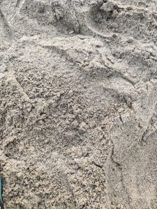 Close-up of fine sand with small ridges and natural texture.
