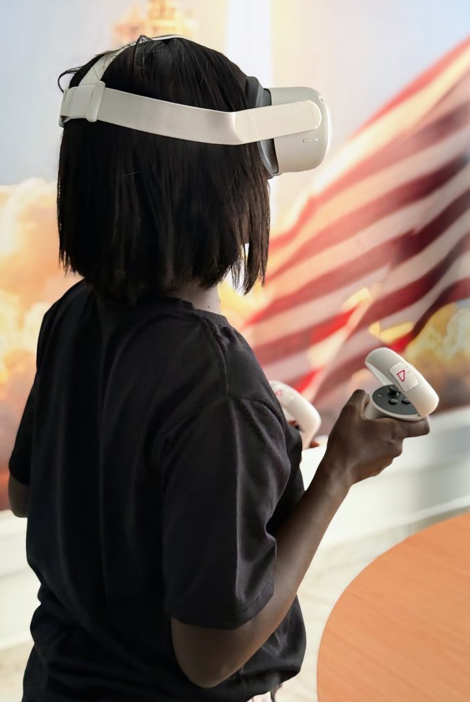 An African lady using VR glasses and controllers for event navigation