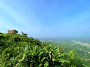 Panoramic view of lush green hills, tropical vegetation and a winding river valley stretching to the horizon, Bangladesh
