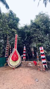 Traditional Theyyam ceremonial equipment displayed outdoors in Kerala, India.