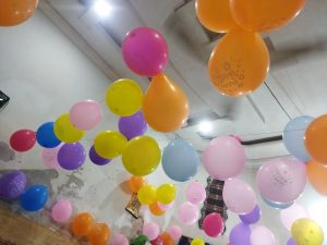 A room filled with colorful balloons in various shades, creating a festive and cheerful atmosphere.
