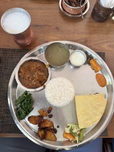 Nepali Thakali Dal bhat set. Traditional Nepali staple meal. Contains rice, bean lentils, mutton curry, vegetables, pickles and Mohi (butter-milk) on the side. 
