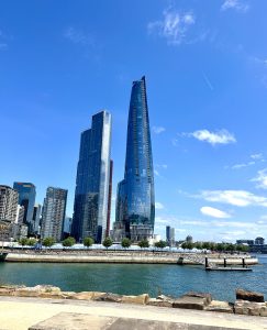 Two tall building rising high and shining over a clear blue sky horizon 
