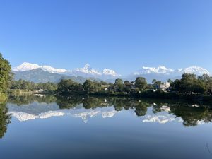 Breathtaking view of the Annapurna Himalayan Range reflected on the calm Phewa Lake on a winter morning, seen from Damside.