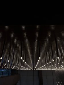 Geometric arrangement of hanging lights creating a vanishing point and sense of infinite depth. 