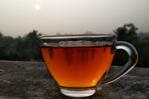 Glass cup of tea on a rooftop during a winter afternoon