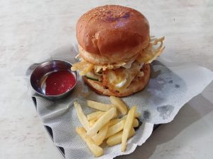 An egg-burger with potato fries and tomato sauce at a Nepali restaurant in Kathmandu, Nepal 