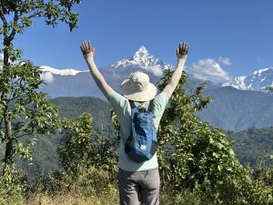 Young man observing Machhapuchhre Himal from Naudanda, Kaski, Nepal.