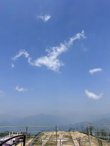 Traces of clouds looking over the horizon from view tower with mountains 