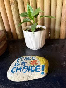 A stone displaying the phrase “peace is a choice,” conveying a powerful message about the importance of choosing peace. 
