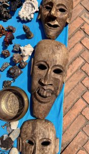 Intricately carved wooden masks and handcrafted artifacts showcasing traditional artistry, craftsmanship, and cultural heritage.
