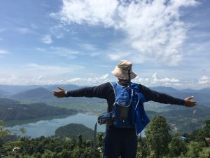 A trekker enjoying the breathtaking view of Begnas Lake from the peaceful hills of Begnaskot, Pokhara.
