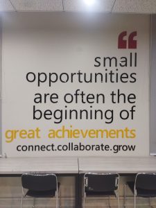 Motivational quote on the wall that says “small opportunities are often the beginning of great achievements. connect. collaborate. grow.
