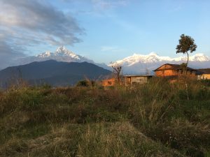 Mesmerizing evening view of the Himalayas from Astam Village, Kaski, as the golden rays of the setting sun paint the snow-capped peaks in breathtaking colors. 