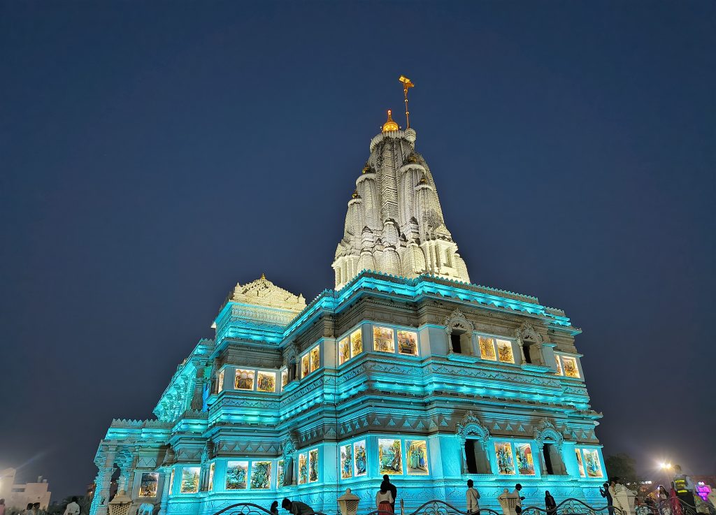 This is a spectacular night shot of the famous Prem Mandir located in Vrindavan, Uttar Pradesh, India. Dedicated to Radha Krishna and Sita Ram, this massive white marble complex is renowned for its architectural grandeur and its vibrant evening light shows.