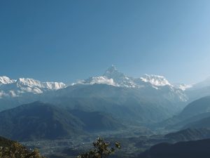 Snow capped Himalayan peaks with Machhapuchhre rising above green valleys, Nepal 