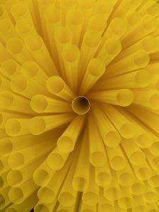 Close-up view of yellow drinking straws arranged in a circular pattern
